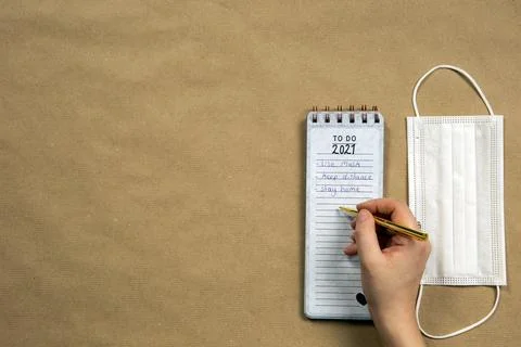 Notepad with to do measures for 2021 Coronavirus, Covid-19 written on with gold Stock Photos