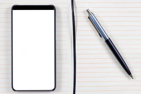 Notepad, elegant pen and bezel less smartphone with blank screen. Foto stock