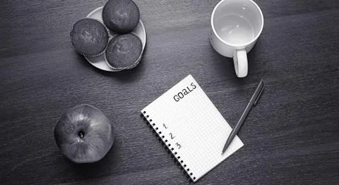 Notepad for entries on the table. Handle and paper on a wooden s Stock Photos