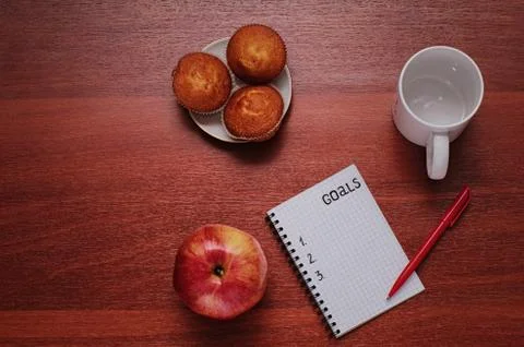 Notepad for entries on the table. Handle and paper on a wooden s Stock Photos