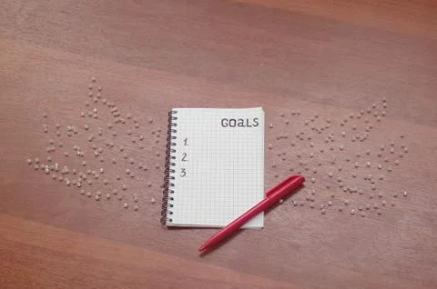 Notepad for entries on the table. Handle and paper on a wooden s Stock Photos