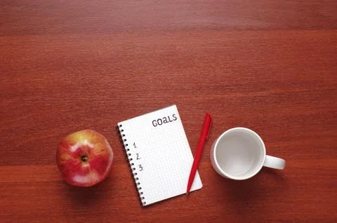 Notepad for entries on the table. Handle and paper on a wooden s Stock Photos
