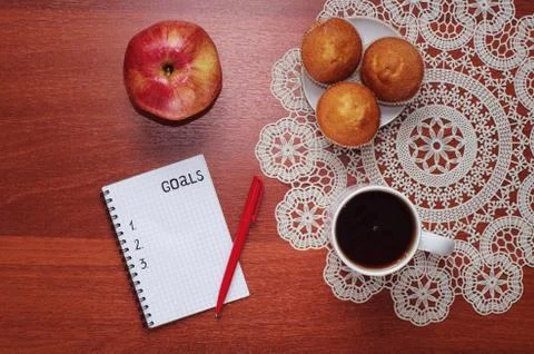 Notepad for entries on the table. Handle and paper on a wooden s Stock Photos