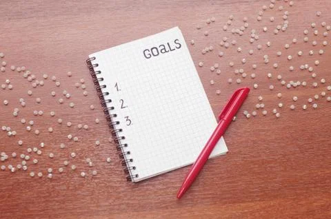 Notepad for entries on the table. Handle and paper on a wooden s Stock Photos