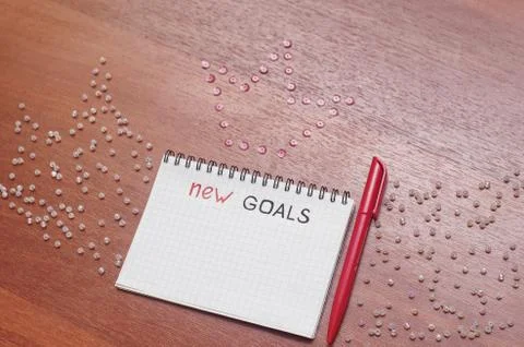 Notepad for entries on the table. Handle and paper on a wooden s Stock Photos