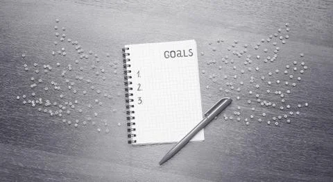 Notepad for entries on the table. Handle and paper on a wooden s Stock Photos