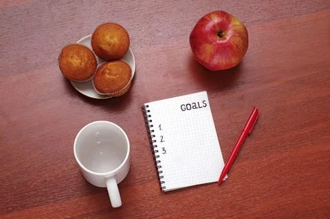 Notepad for entries on the table. Handle and paper on a wooden s Stock Photos