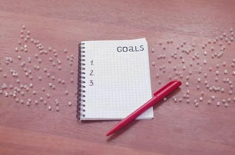 Notepad for entries on the table. Handle and paper on a wooden s Stock Photos