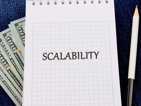 A notepad features the word scalability written in bold Stock Photos