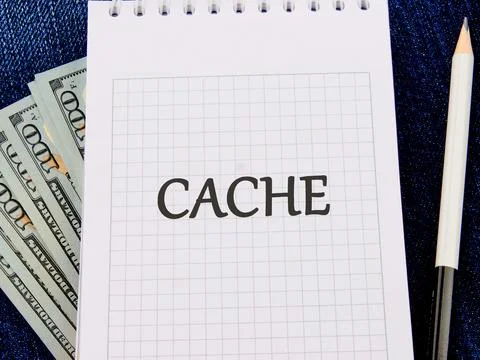 A notepad featuring the word cache displayed prominently on a grid pattern, a Stock Photos