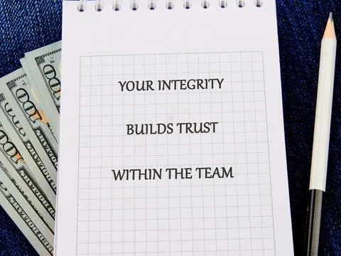 A notepad with a grid pattern displays a motivational message about integri.. Stock Photos