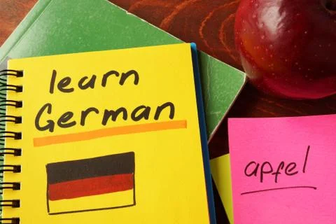 Notepad with learn German on the table. Stock Photos