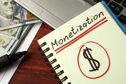 Notepad with monetization on the table. Stock Photos