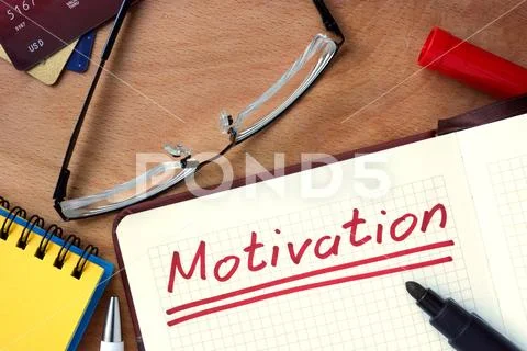 Notepad with Motivation on office wooden table. Stock Photos