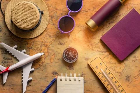Notepad for note with passport, binoculars, pencil, compass, airplane on pape Stock Photos