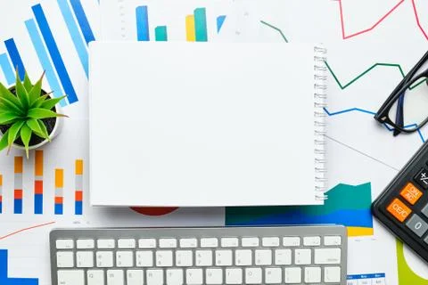 Notepad for notes copy space on charts and financial statements with keyboard Stock Photos