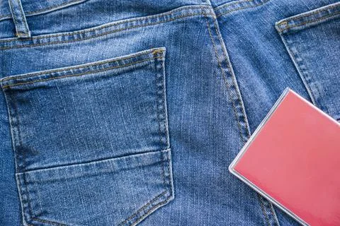 A notepad for notes rests on blue jeans. Stock Photos
