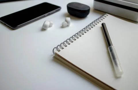 Notepad for notes on the rings and a black felt-tip pen. Workplace in the office Stock Photos