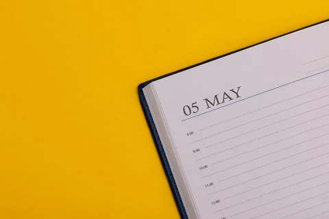Notepad or diary with the exact date on a yellow background. Calendar for May 스톡 사진