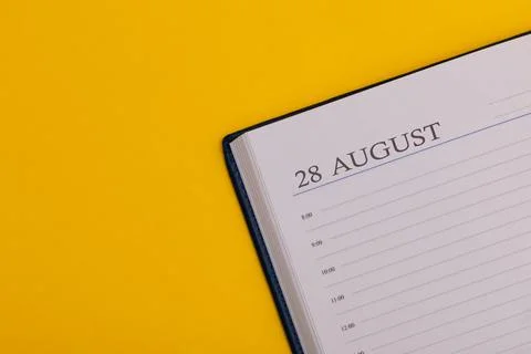Notepad or diary with the exact date on a yellow background. Calendar for Aug Фото