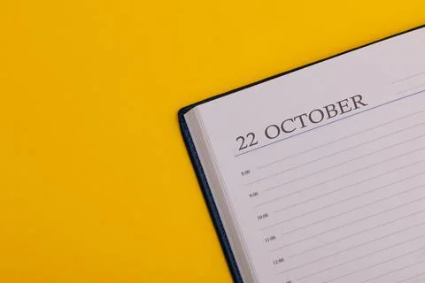 Notepad or diary with the exact date on a yellow background. Calendar for Oct Stock Photos