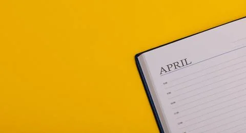Notepad or diary on a yellow background. Calendar for April. Spring time. Spa 写真素材