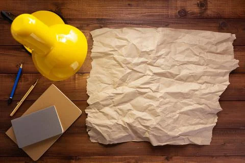 Notepad or paper notebook and lamp at wooden table Stock Photos