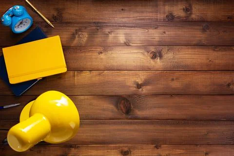 Notepad or paper notebook and lamp at wooden table Stock Photos