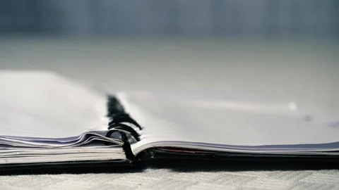 Notepad paper blowing in office Stock Footage 313547399