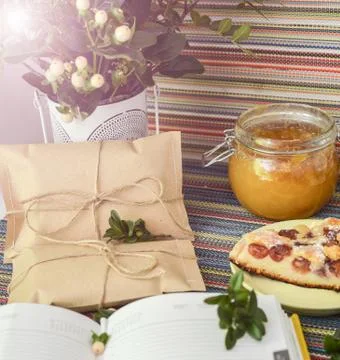 Notepad, paper envelope and piece of pie on the colorful tablecloth Stock Photos