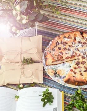 Notepad, paper envelope and piece of pie on the colorful tablecloth Stock Photos