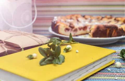 Notepad, paper envelope and piece of pie on the colorful tablecloth Stock Photos