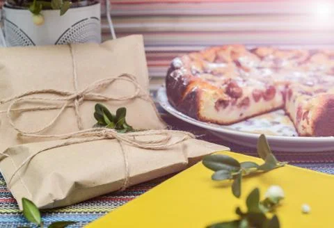 Notepad, paper envelope and piece of pie on the colorful tablecloth Stock Photos