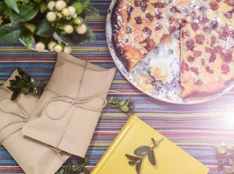 Notepad, paper envelope and piece of pie on the colorful tablecloth Stock Photos