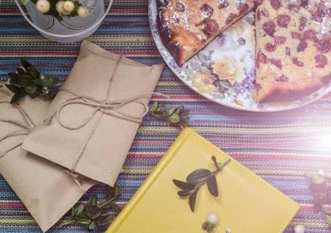 Notepad, paper envelope and piece of pie on the colorful tablecloth Stock Photos