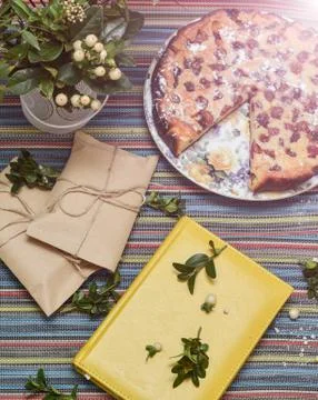 Notepad, paper envelope and piece of pie on the colorful tablecloth Stock Photos