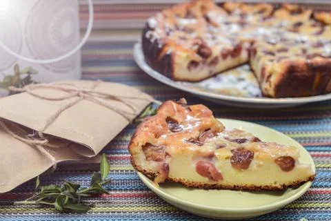 Notepad, paper envelope and piece of pie on the colorful tablecloth Stock Photos
