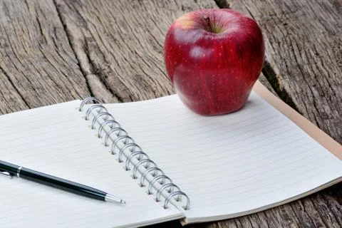 Notepad with pen and apple fruit on table 스톡 사진