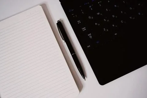 Notepad pen and notebook on white table Foto stock