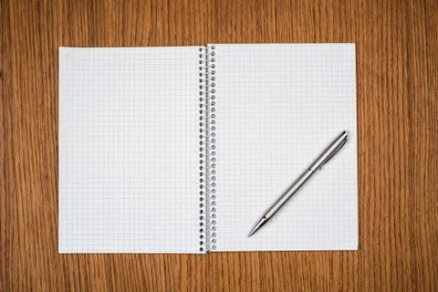 Notepad with pen lying on the table Stock Photos