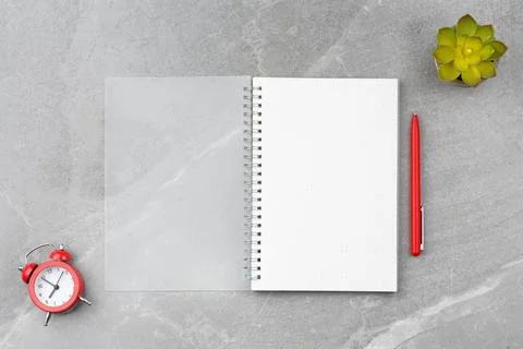 Notepad with a pen on a marble background. Stock Photos