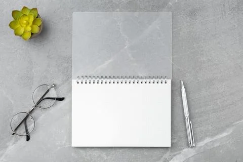 Notepad with a pen on a marble background. Stock Photos