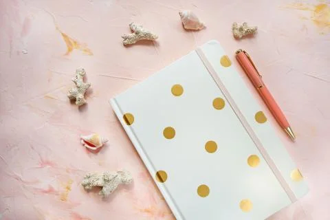 Notepad, pen, sea shells and corals on workspace Stock-Fotos