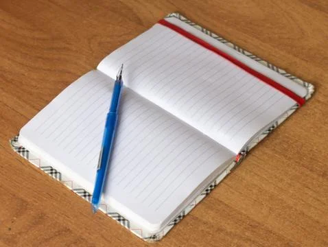 Notepad with pen on the table Stock Photos