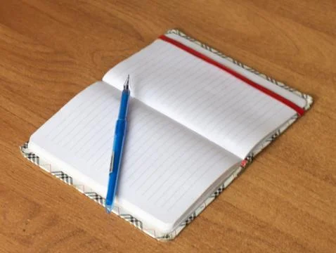 Notepad with pen on the table Stock Photos