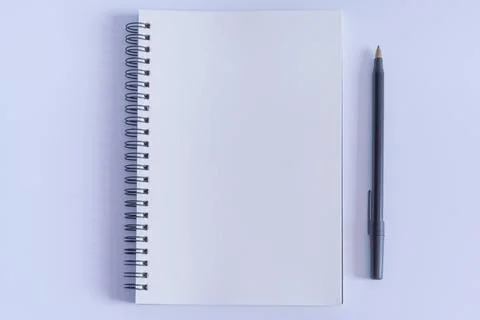 Notepad with pen on white background. Flat lay with open book page Stock Photos