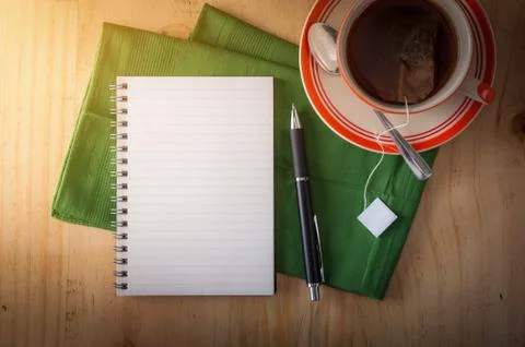 Notepad with pen on wood table Stock Photos