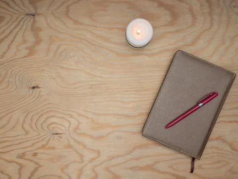 Notepad with a pen on a wooden table. Stock Photos