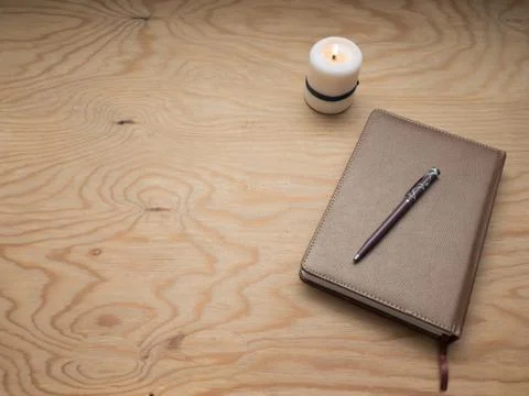 Notepad with a pen on a wooden table. Stock Photos