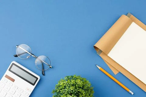 Notepad with pencil, glasses, note sheet and plant Stock-Fotos